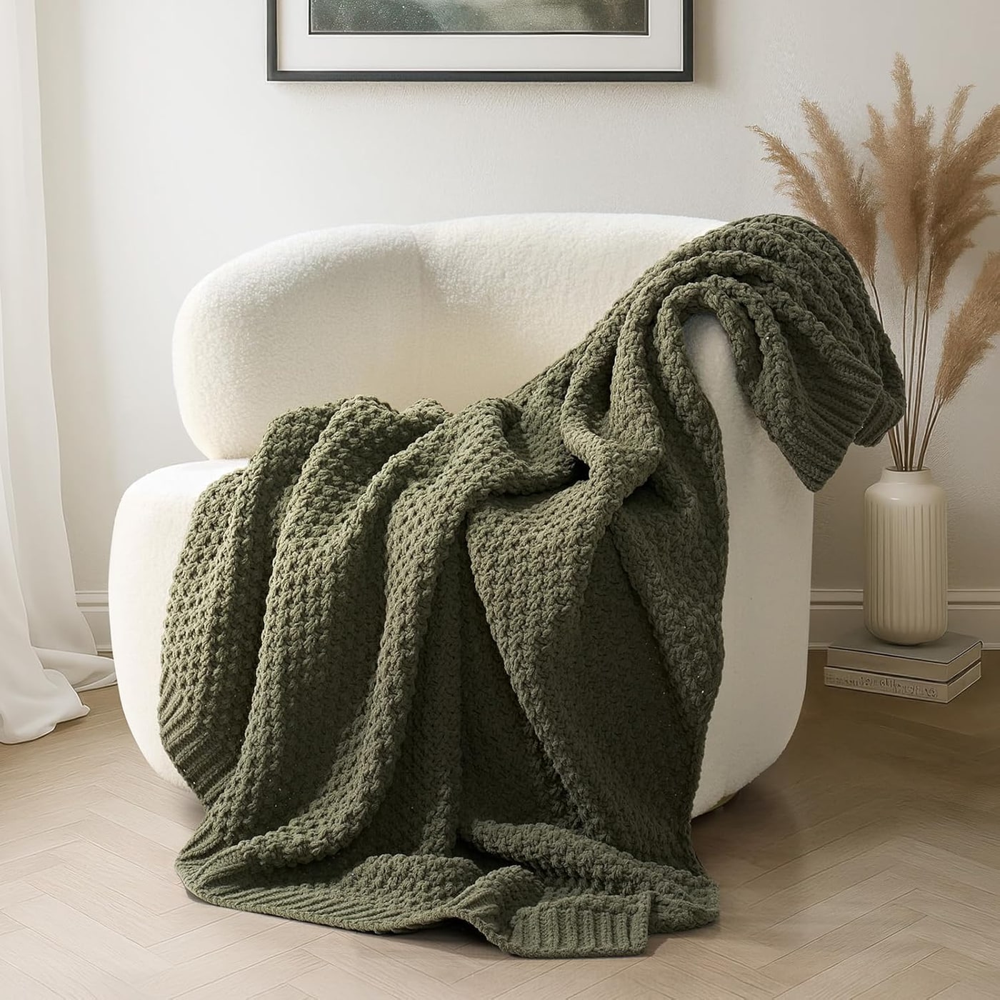 Olive green chenille knit throw blanket with sculpted moss stitch texture, draped for display
