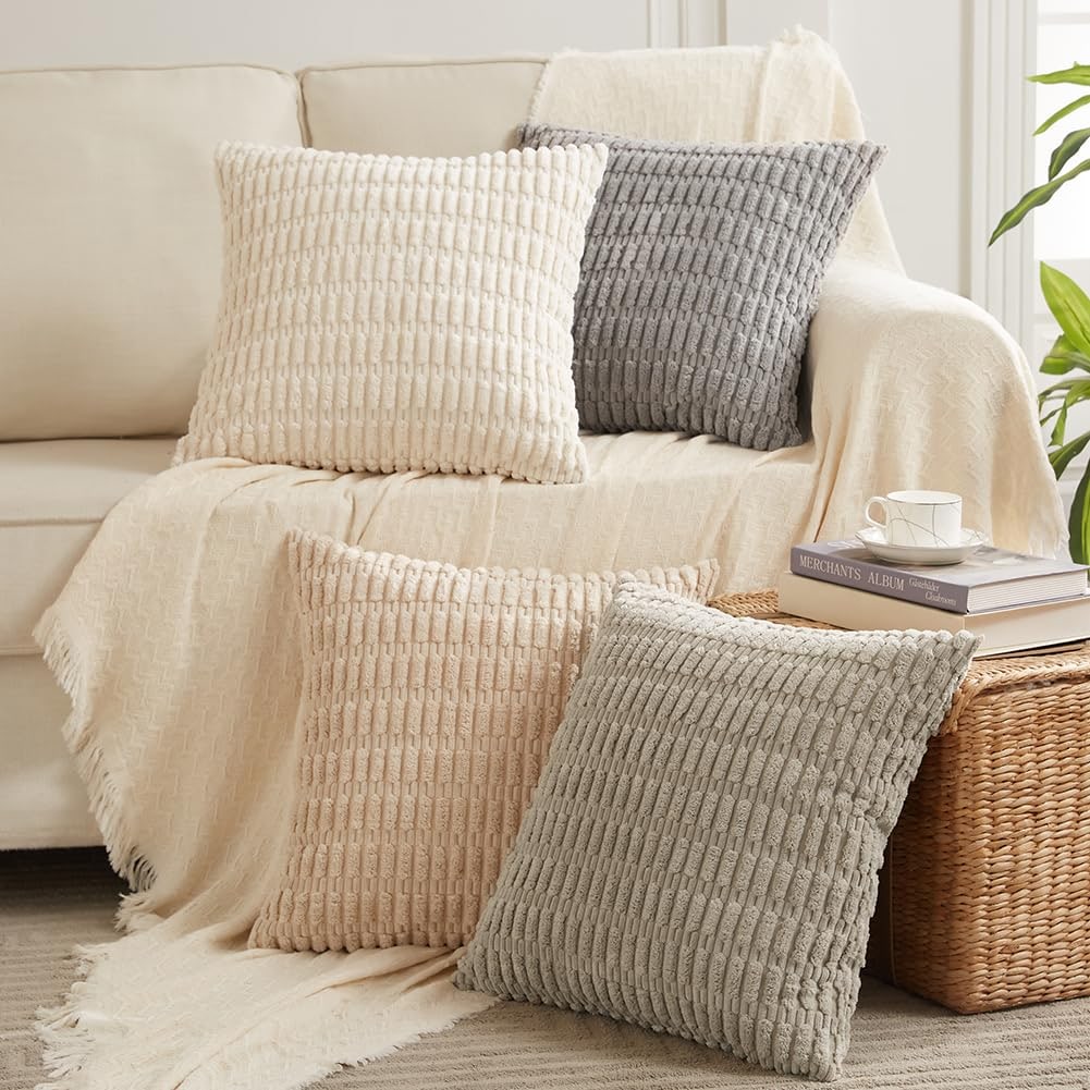 Four corduroy striped throw pillow covers in neutral tones grouped on a sofa.