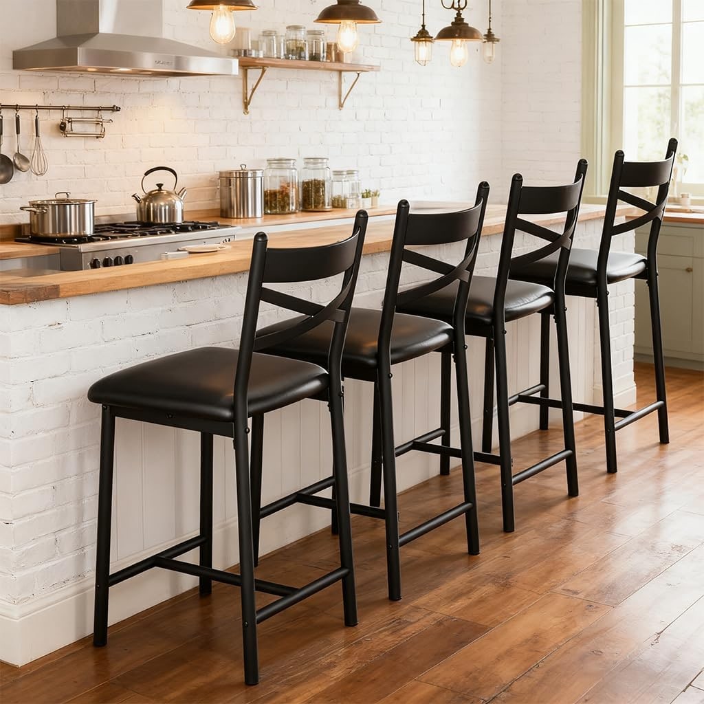 A set of four black counter-height bar stools with curved backrests and cushioned faux leather seats