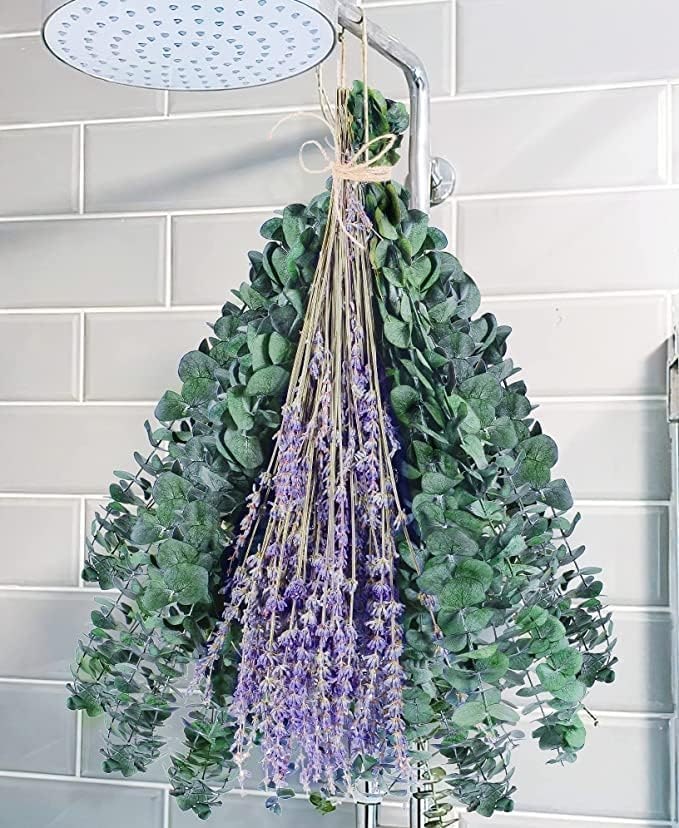 A bundle of preserved eucalyptus, lavender, and chrysanthemums tied with hemp rope and hung in a shower.