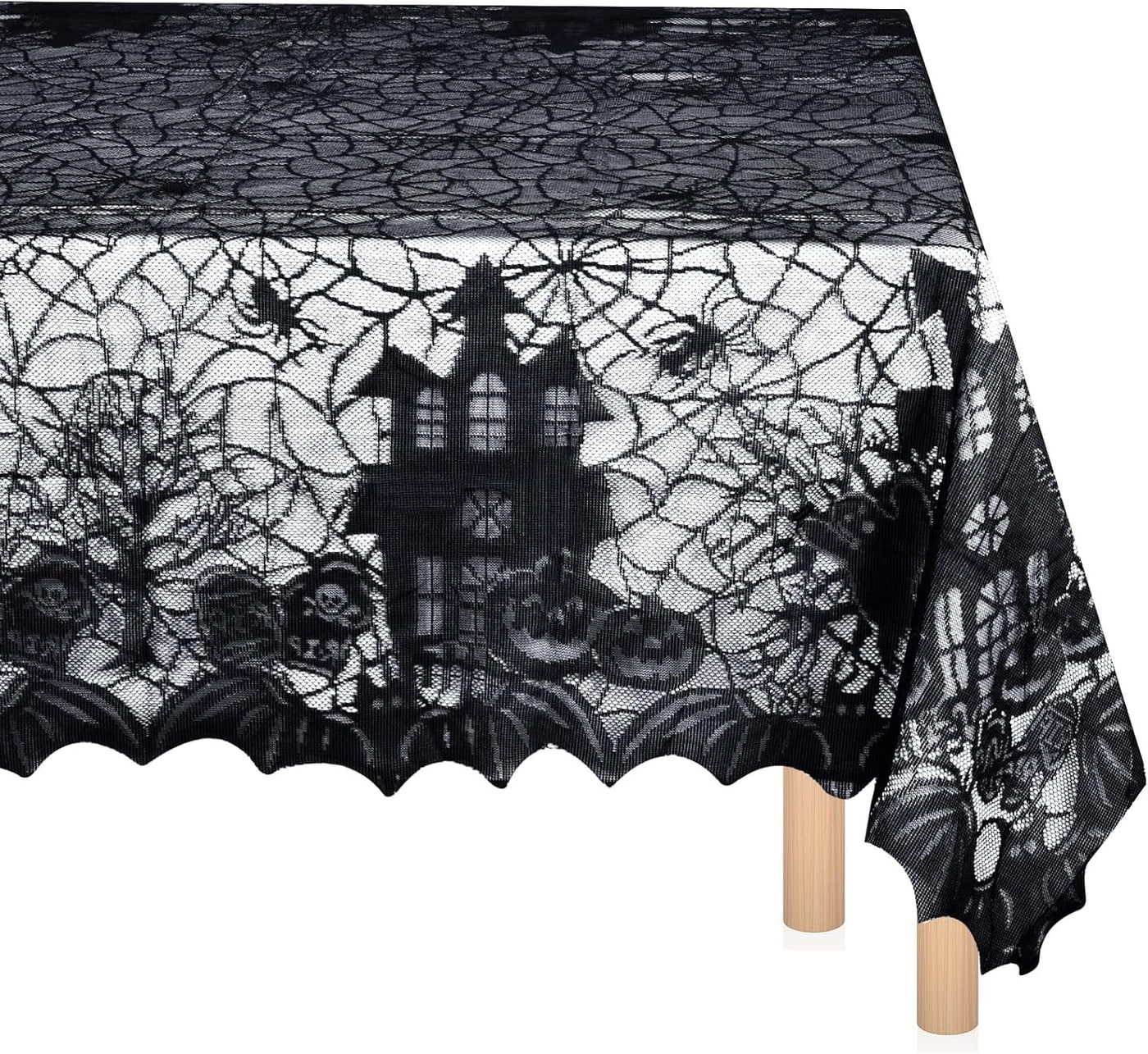 A black lace tablecloth with spider web, pumpkin, bat, and skull motifs draped over a rectangular dining table