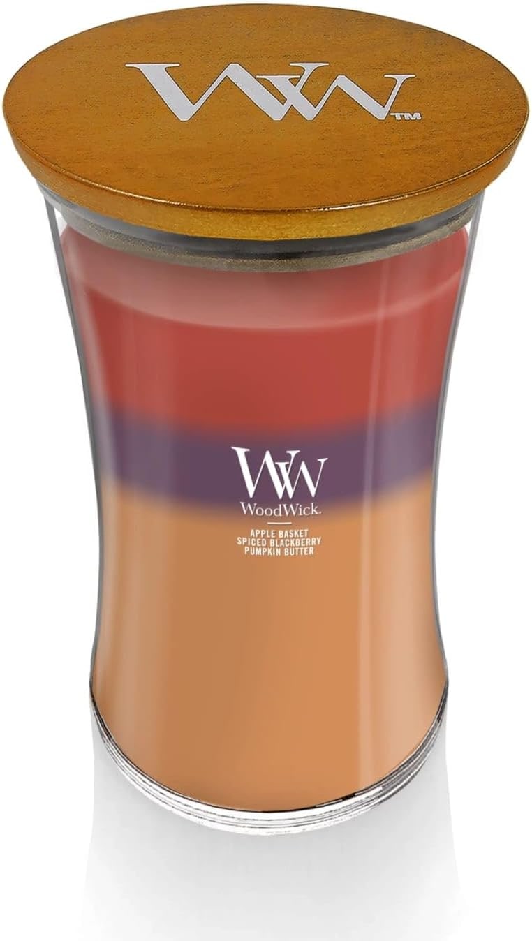WoodWick Large Trilogy Hourglass Candle with wooden crackling wick and layered autumn-colored wax in a curved glass jar