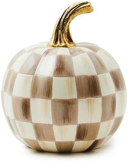 A small, hand-painted resin pumpkin with a signature checkered pattern and a shiny gold stem, displayed on a tabletop.