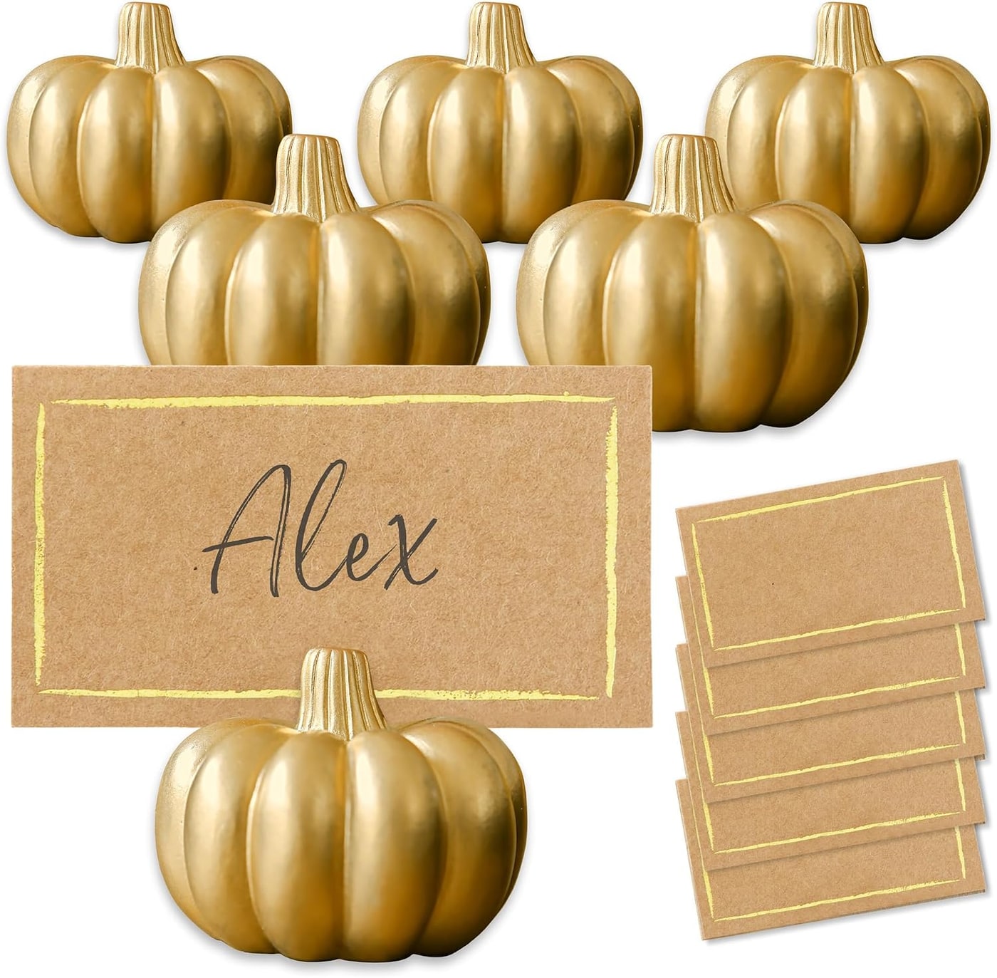 Set of six gold-finished mini pumpkin place card holders with gold-foiled kraft cards displayed on a fall-themed table