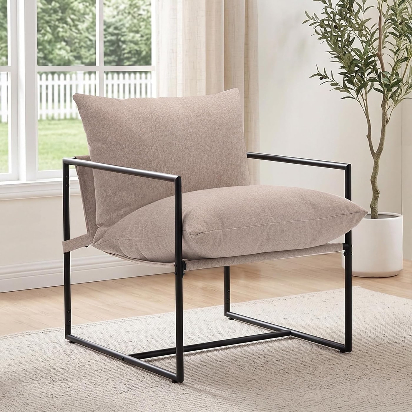 Nestvala modern upholstered sling accent chair with curved metal frame and linen-look cushion in a neutral color.