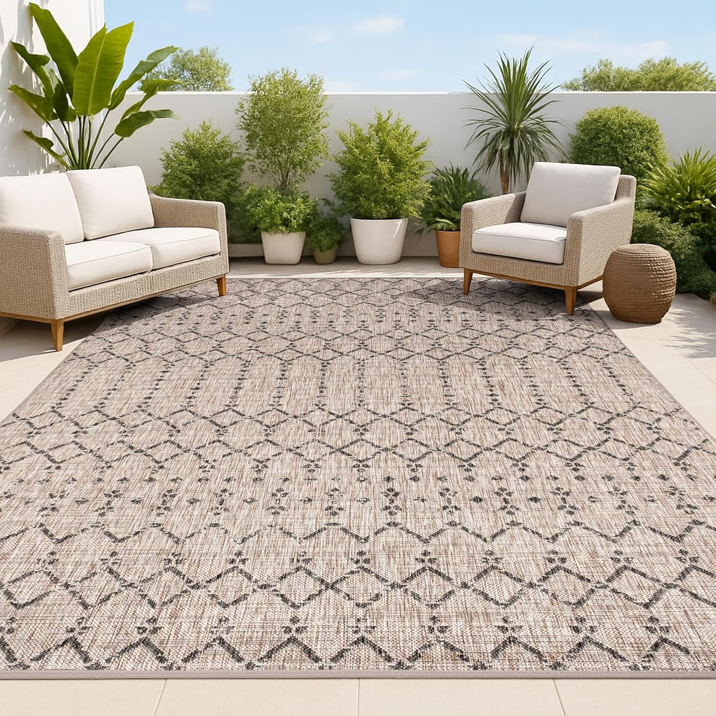 Moroccan geometric flat-woven area rug in natural tan and black, styled on a patio floor