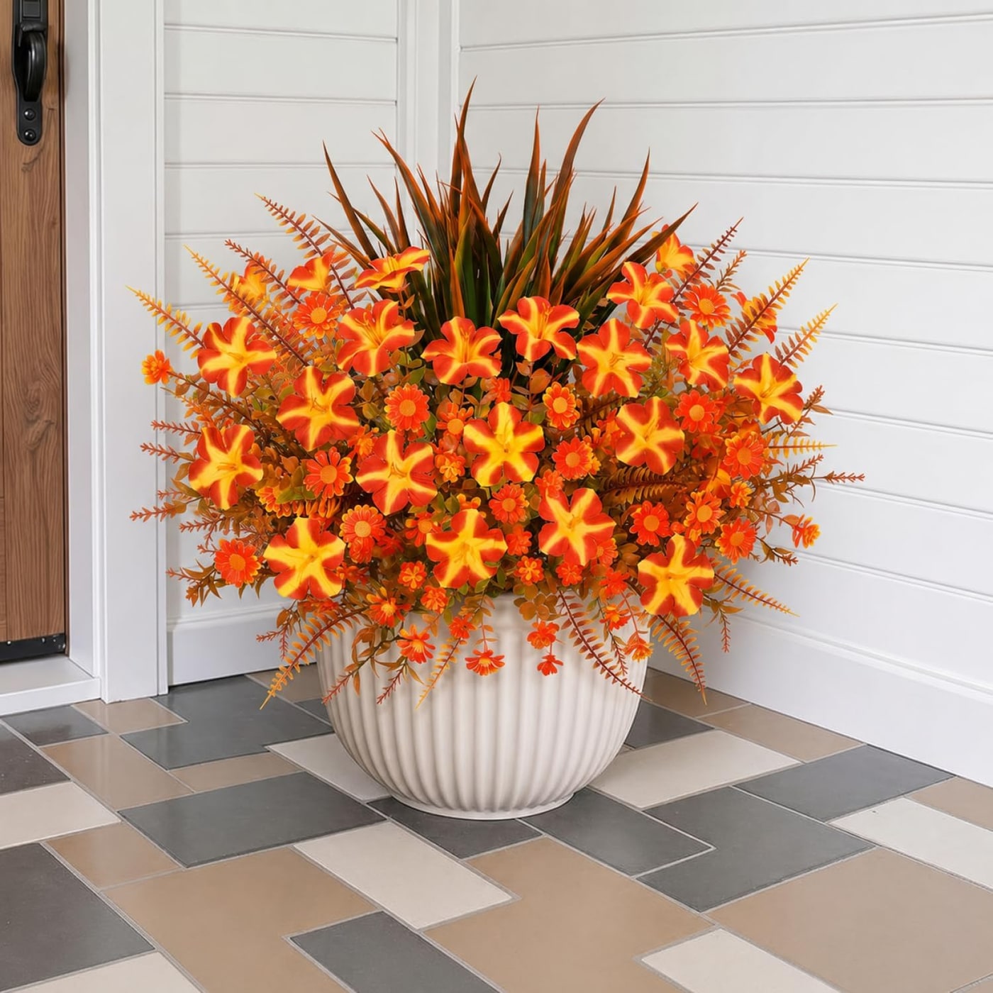 A dozen mixed-color artificial flower bouquets with eucalyptus stems, displayed together on an outdoor table.