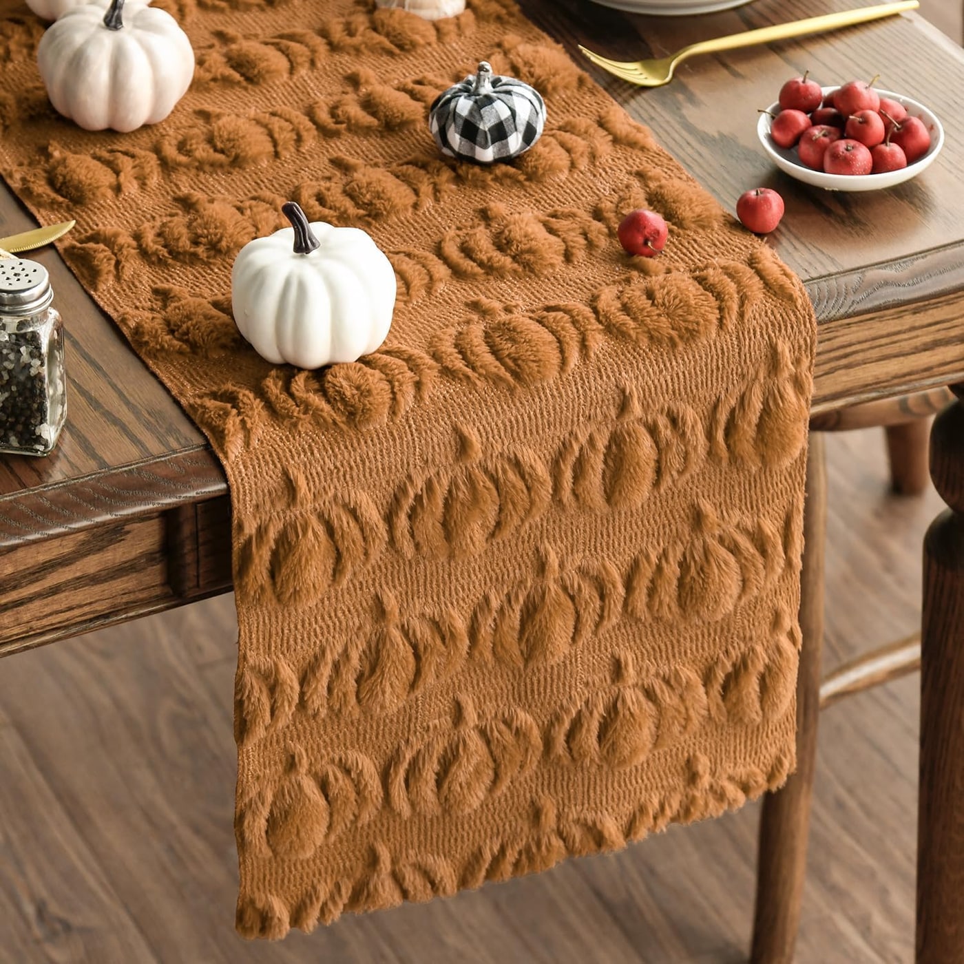 Plush pumpkin-themed faux fur table runner in a soft caramel color, styled across a dining table