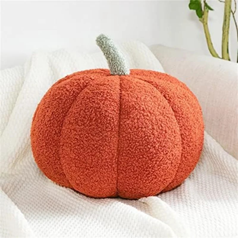 Three-dimensional plush pumpkin-shaped throw pillow in striped fleece, shown in warm fall hues