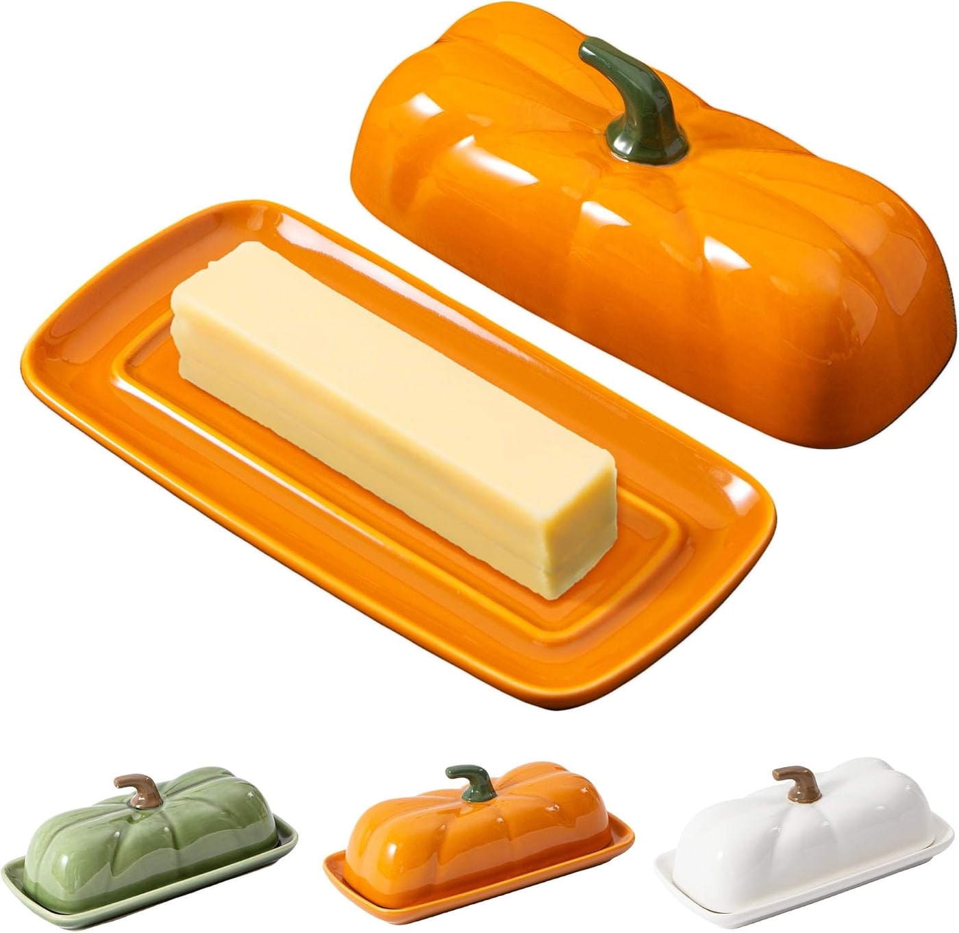 A sculpted ceramic pumpkin-shaped butter dish in orange with a fitted lid, pictured on a countertop