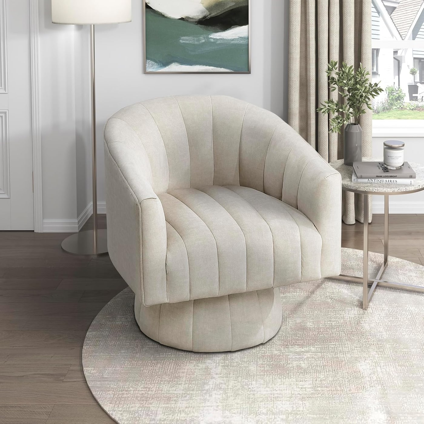 Rounded velvet barrel accent chair with channel stitching on a swivel base in taupe.