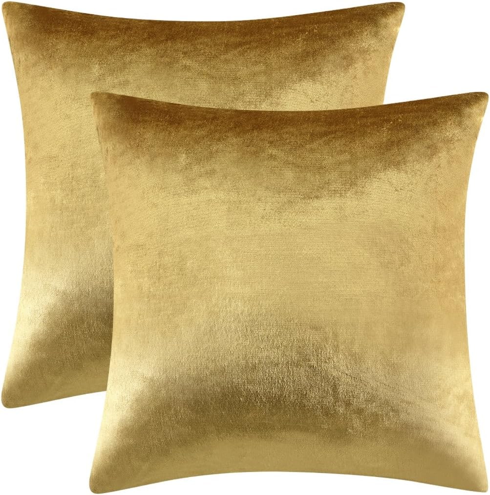 Set of two square velvet throw pillow covers in a gold shade displayed on a neutral background